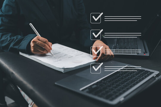 Businesswoman hand signing document with digital check marks on checklist representing approval process , compliance audit workflow management for quality control and assurance concept.