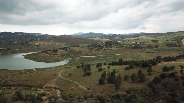 Aerial shot of part of Lake La Vinuela, a reservoir in southern Spain, showing houses near the lake, which is fed by the waters of the Rio Guaro