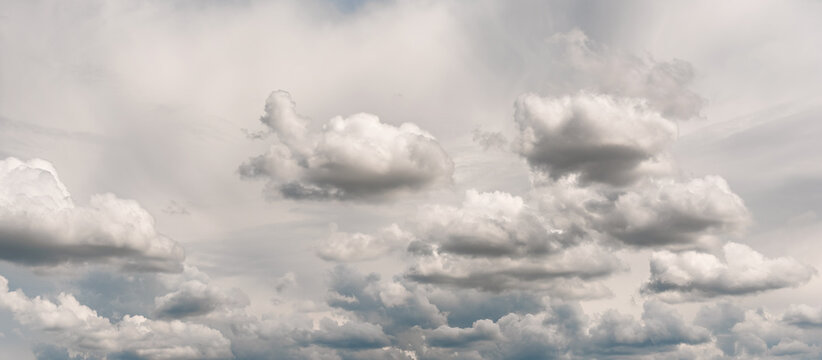 Cirrus and cumulus clouds in the sky. Beautiful multilayered clouds. Banner