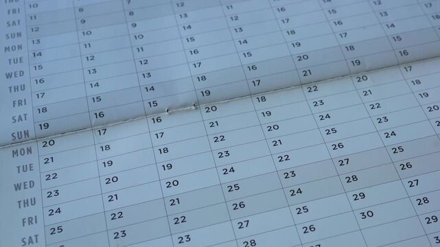 View of yearly table calendar with dates. Planning for appointments and travels for future concept. Side panning.