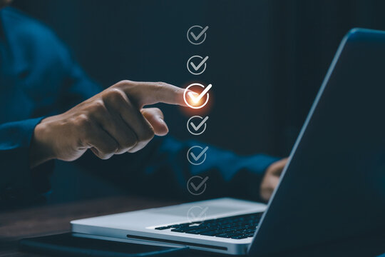 Digital checklist with completed tasks displayed above a laptop, representing workflow management, productivity, quality control, business efficiency, compliance, and successful execution.
