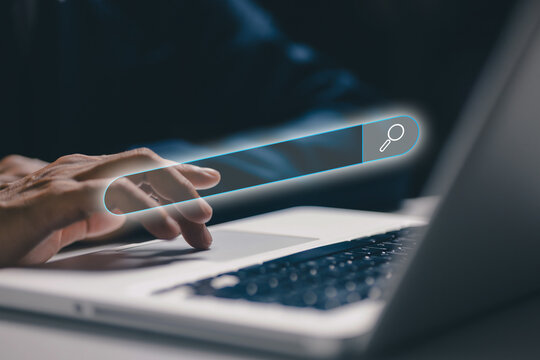 Digital search bar interface floating above a laptop, representing online search, web browsing, information discovery, internet technology, search engine optimization, and modern digital research.