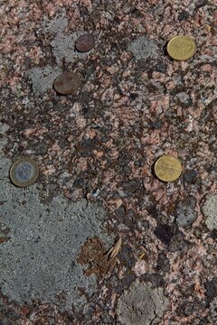 Coin offerings on sacred Aljava Kunnati kivi (also known as Ukukivi) located in the village of Aljava on the island of Muhu, Estonia.