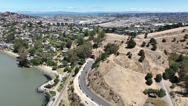 Aerial drone view of the Point Richmond hillside park and historic tunnel in Richmond California with the Chevron refinery San Pablo Bay and surrounding neighborhood under clear sunny skies