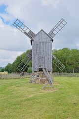 Obraz premium Historic wooden post mill (pukktuulik) located at Angla Windmill Park located on Saaremaa Island in Estonia, Europe.