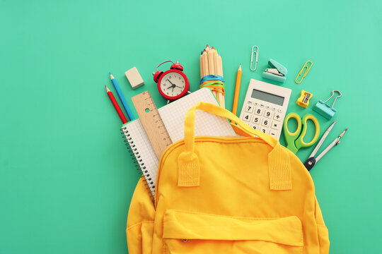 Back to school concept over pastel background. Top view