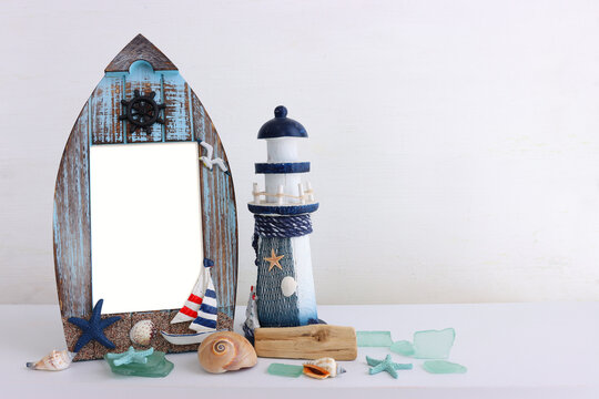 summer background with boat, blue sea glass and shells