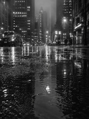 Fototapeta premium Rainy urban street at night with reflections on wet asphalt 