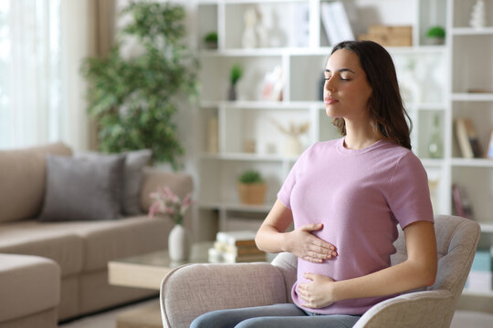 Serious woman having healthy bowel tract on armchair
