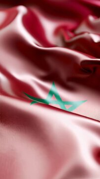 Morocco national flag waving and filling the entire vertical frame, cinematic close-up video showcasing the iconic red fabric and green star for patriotic backgrounds