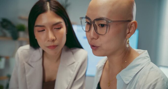 Young Asian business colleagues discussing project on computer at office. Corporate teamwork meeting, marketing report analysis, strategy planning development, professional manager advice concept.