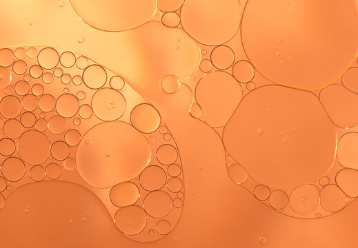Abstract clear orange water bubbles essential oil beauty collagen Serum Repair cell background.	
