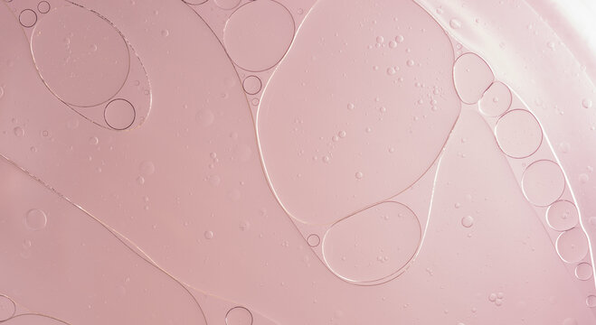 Abstract Pink water bubbles essential oil beauty collagen Serum Repair cell background.	