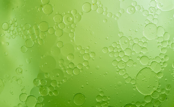 Abstract Green water bubbles essential oil beauty collagen Serum Repair cell background.	