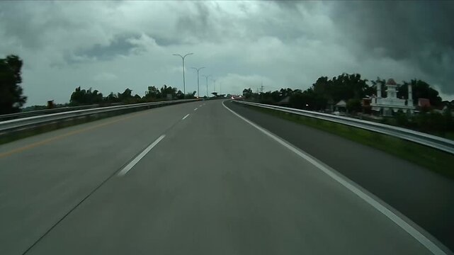 Rear Dashcam Driving on Nganjuk Toll Road Passing Village and Mosque Toward Surabaya, East Java, Indonesia - Editorial