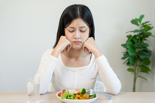 slim body asian women very bored diet food, dieting female choose low calories food for diet. Good healthy food. weight lose, balance, control, reduce fat, routines, exercise, body shape