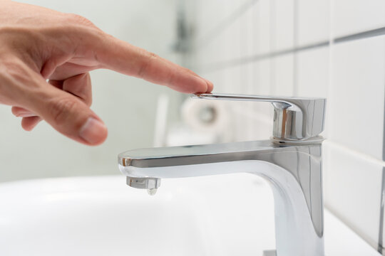 Save water. Volunteer keeps turning off the running water in the bathroom to protect environment. Greening planet, reduce global warming, Save world, life, future, risk energy, crisis , water day.