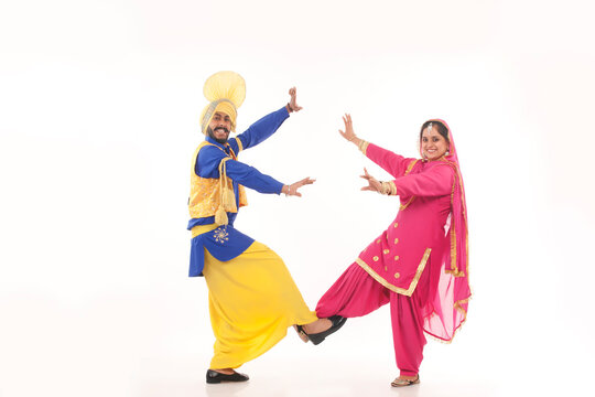 Portrait of Sikh couple doing bhangra dance
