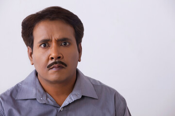 Obraz premium Close up portrait of tensed man on a white background.