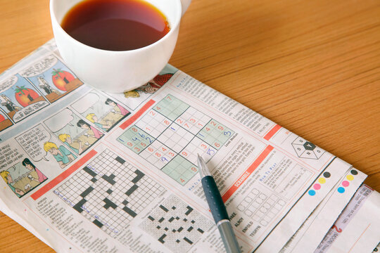Coffee with newspaper crossword