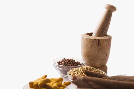 Bowls of spices with wooden mortar and pestle 