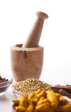 Bowls of spices with wooden mortar and pestle 