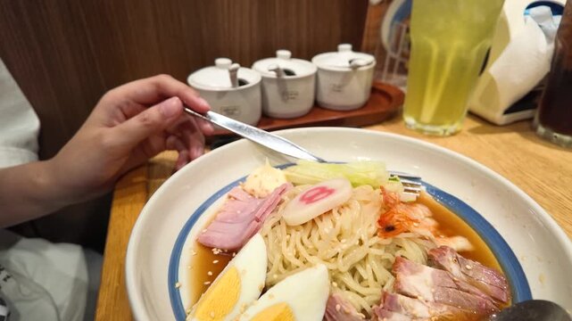 Close Up of Person Eating Japanese Hiyashi Chuka Cold Ramen Noodles