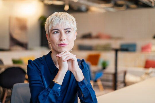 Thoughtful businesswoman contemplates her career in the office