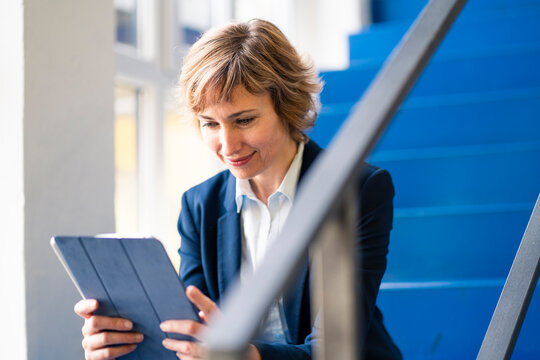 Female entrepreneur using digital tablet in factory