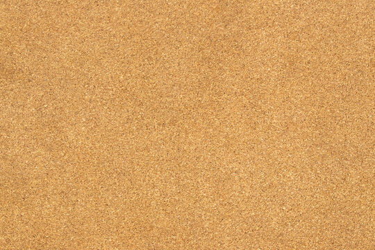 Natural brown cork board texture background with fine granular surface pattern