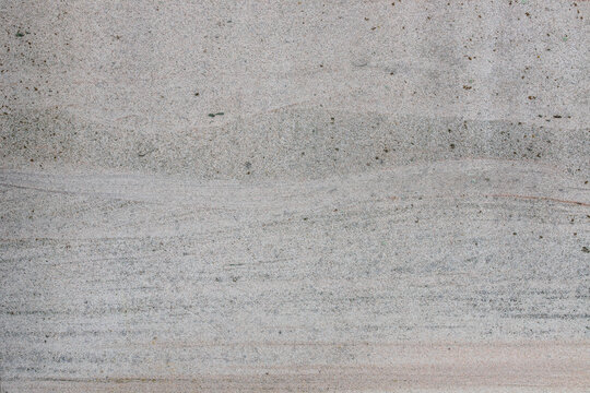 Rough grey sandstone surface texture background with fine horizontal grain lines