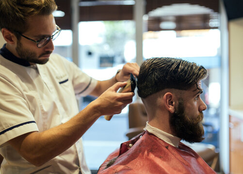 Barber shaving head of a customer