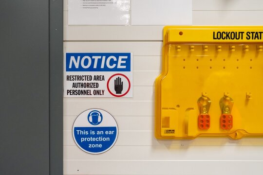 Industrial safety signs and lockout station in restricted work area