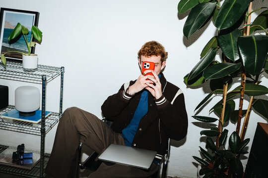 The smartphone becomes part of a relaxed lifestyle for a man at home.