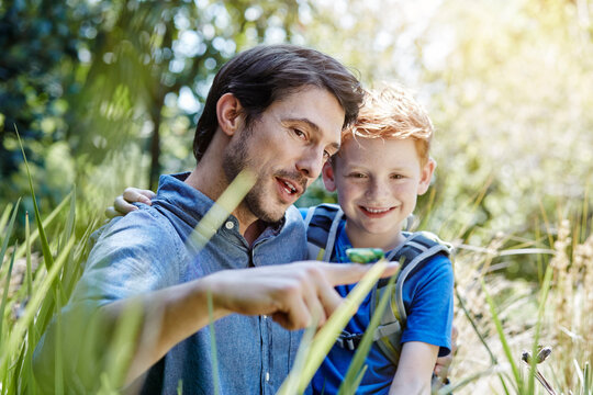 Father showing son a grasshopper