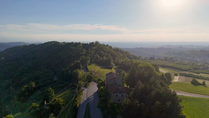 Obraz premium Aerial View of Historic Italian Church on a Wooded Hillside