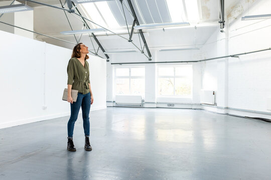 Businesswoman with tablet PC standing in office