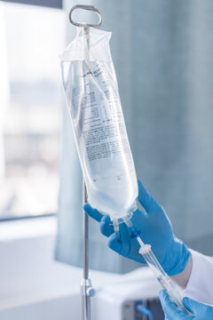 Nurse adjusting intravenous drip