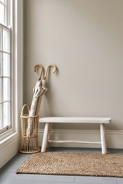 Modern coastal style corner featuring a low bleached oak bench, rattan umbrella stand, and woven sisal mat in soft morning light