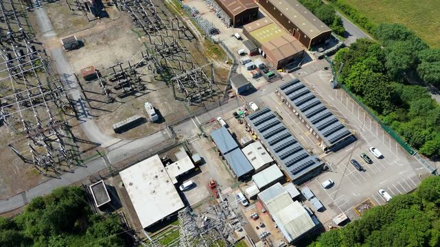 Close up aerial view of electrical substation infrastructure, high voltage transformers and busbars