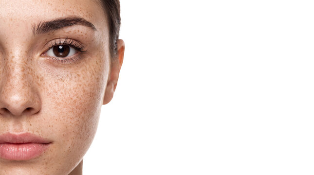Woman face portrait closeup freckle skin beauty model with natural freckles, half face crop, brown eye, neutral expression