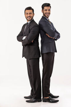 Two corporate employees in formal business suit Standing back to back adjacently against white background.