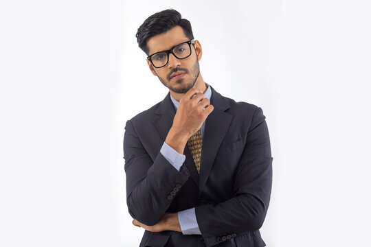 Portrait of a corporate employee in formal business suit against plain backdrop.