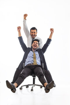 Corporate employee in formal clothing ecstatic as they celebrate their win together.
