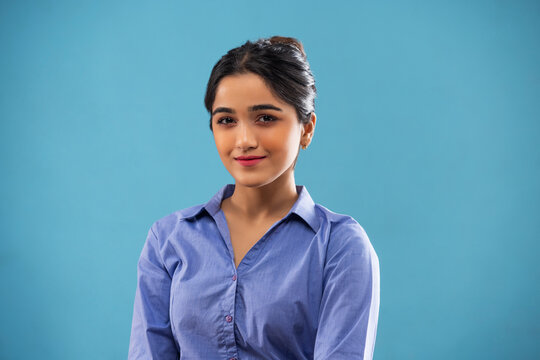 Young girl in formal outfit posing in front of camera