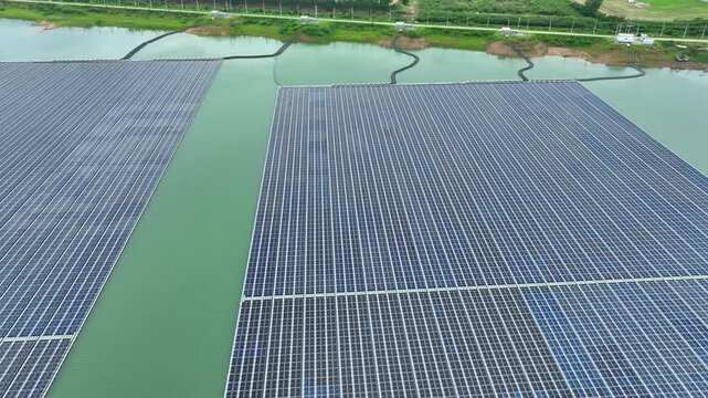 Aerial view of expansive floating solar technology installed on a reservoir, highlighting the water-energy nexus, carbon reduction efforts, and innovative clean power generation. Thailand. 4k.
