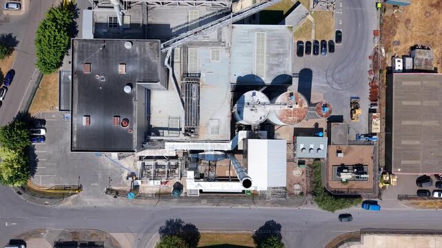 Close up aerial view of industrial biomass power plant with waste-to-energy conversion infrastructure