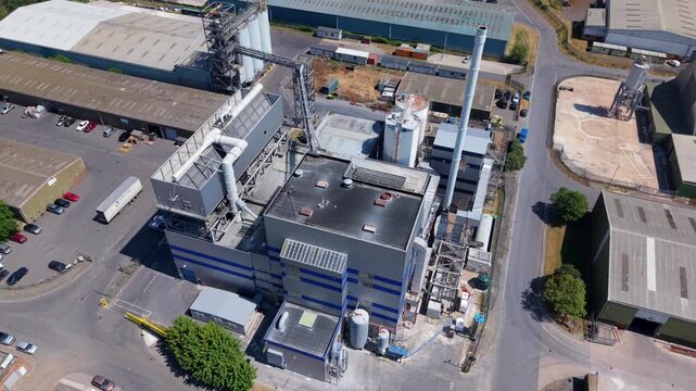 Close up aerial view of industrial biomass power plant with waste-to-energy conversion infrastructure