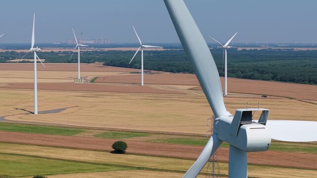 Cinematic close up aerial view of wind turbine nacelle rotating for UK net zero goals