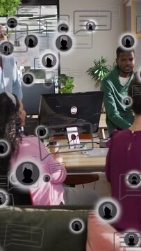 Vertical video: Business team reacting to phone ping, chat bubbles layering over faces and monitor